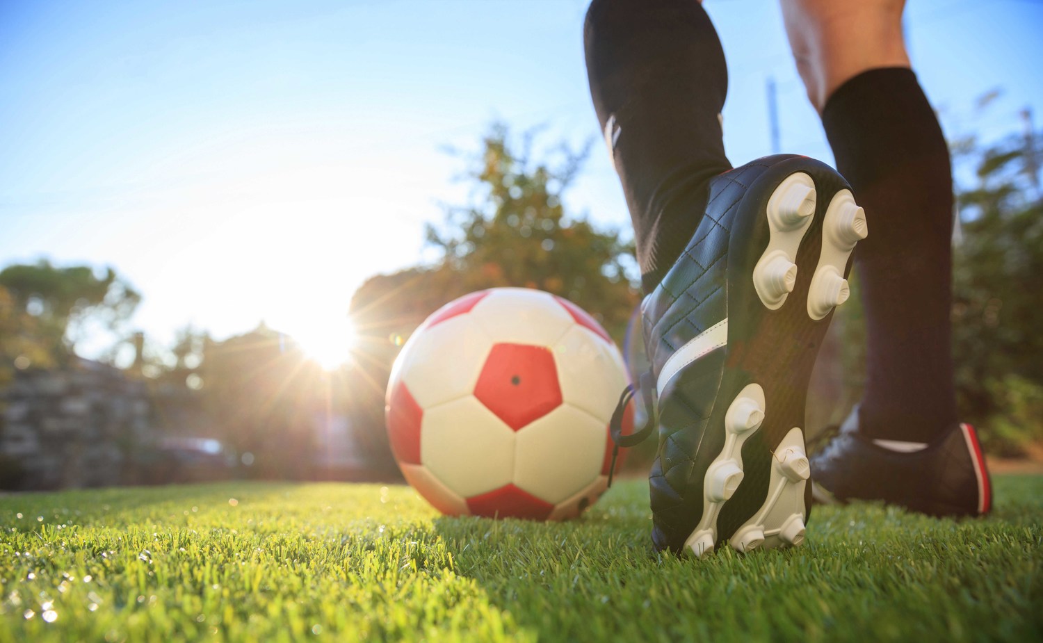 Woman and a soccer ball on the grass menor